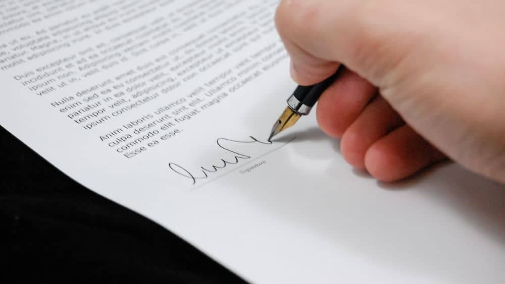 legal document signed by a person using fountain pen
